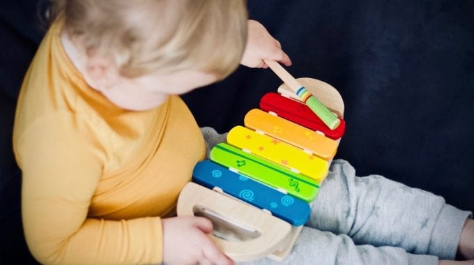 Child Playing On Xylophone