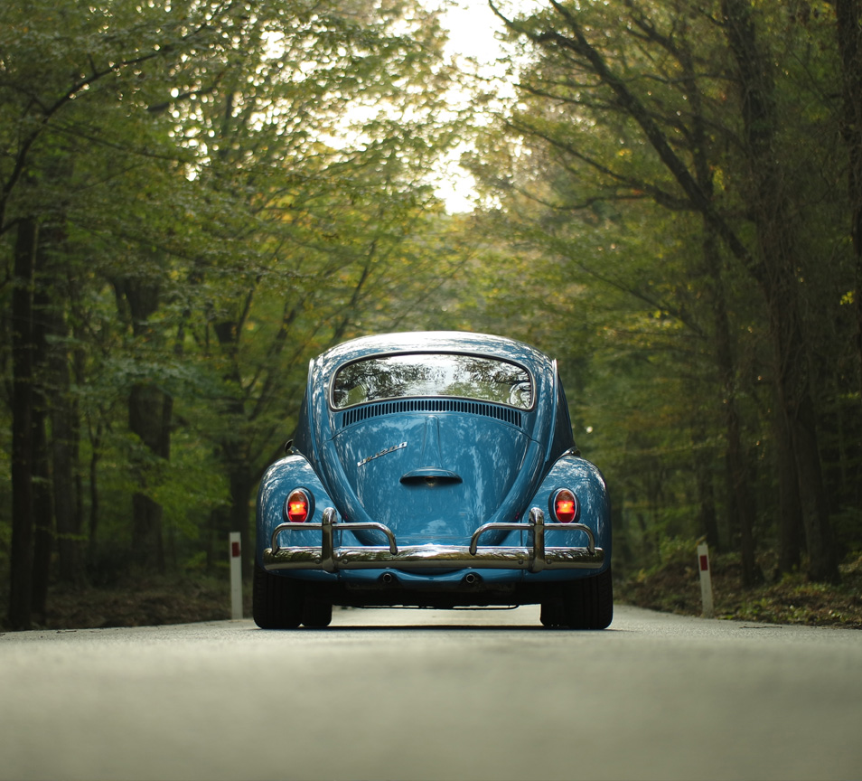 rear view of a blue VW driving down a country land looking for a Motor trade accountant