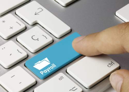 finger pressing button named payroll on keyboard