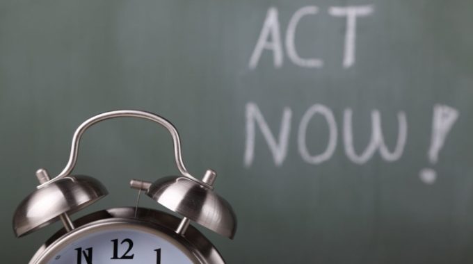 Act Now Words On Blackboard With Clock As Paper Forms To Register For VAT Are Removed
