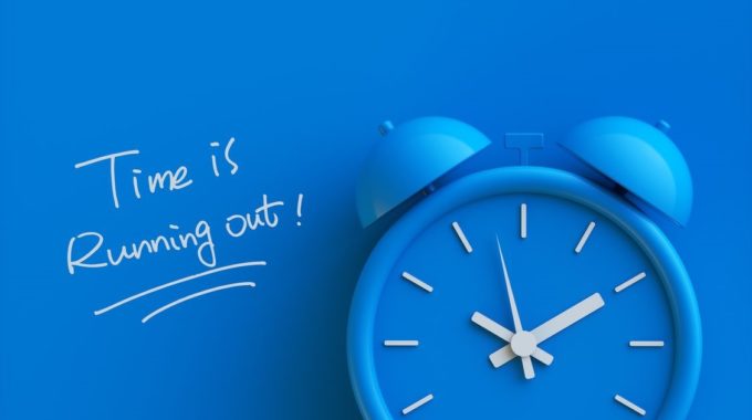 Time Is Running Out On A Blue Background With A Clock Indicating The National Insurance Contributions Deadline Has Been Extended